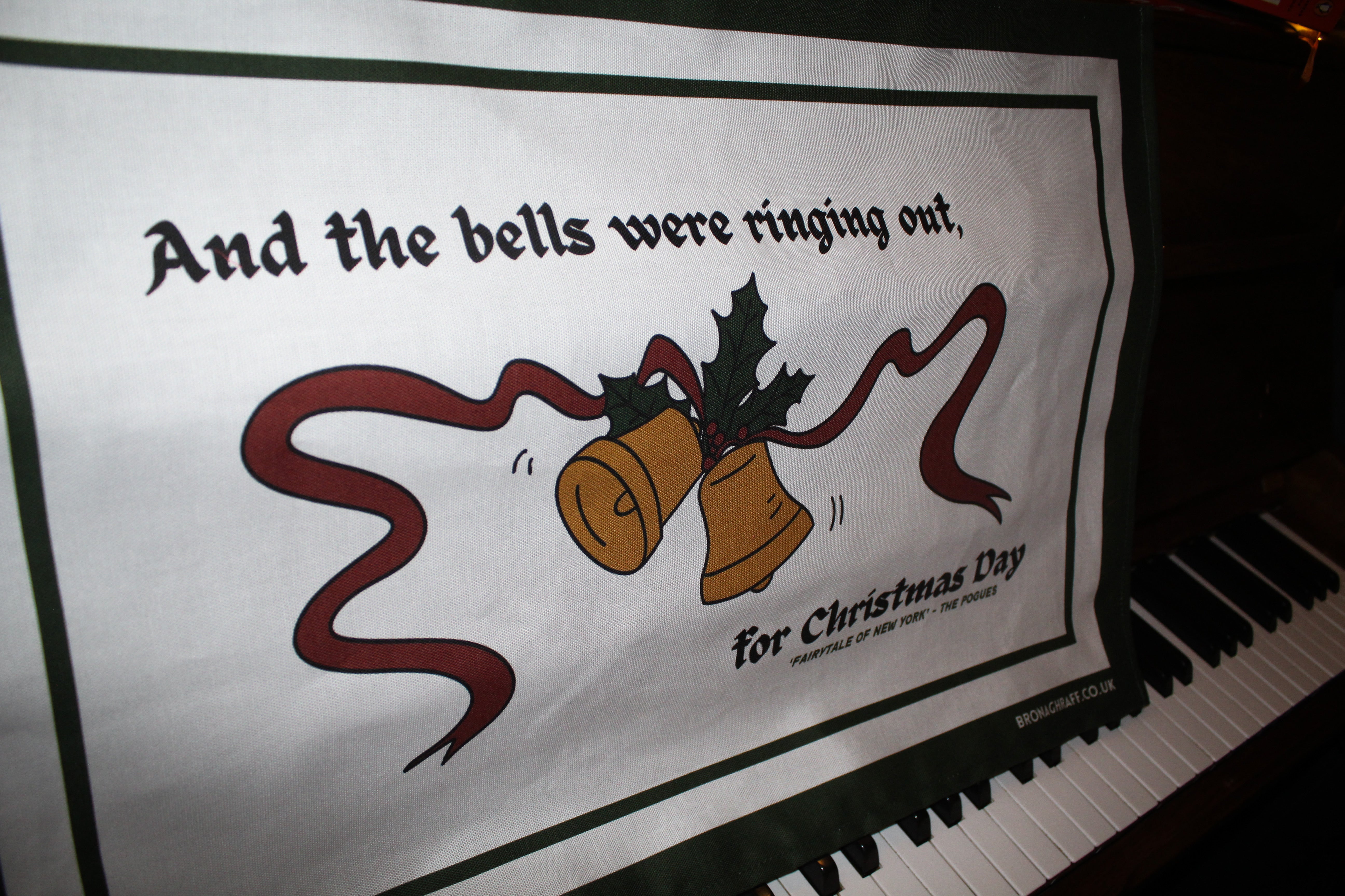 Hand-drawn Irish tea towel with festive bells and Pogues lyrics to the Fairytale of New York