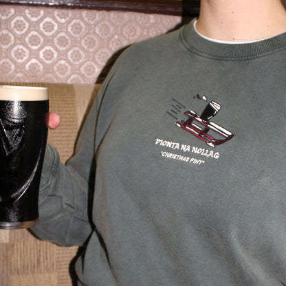 Bronagh holding a pint of guinness with her new green irish christmas jumper 